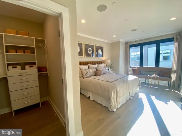 a bathroom with a double vanity sink mirror and next to a window