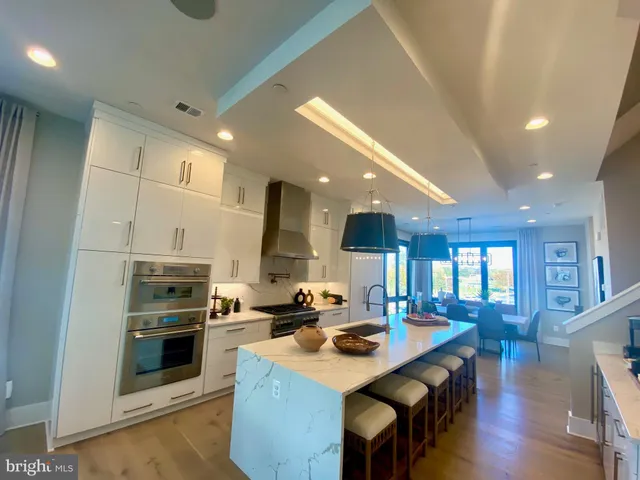 a kitchen with a sink stainless steel appliances and cabinets
