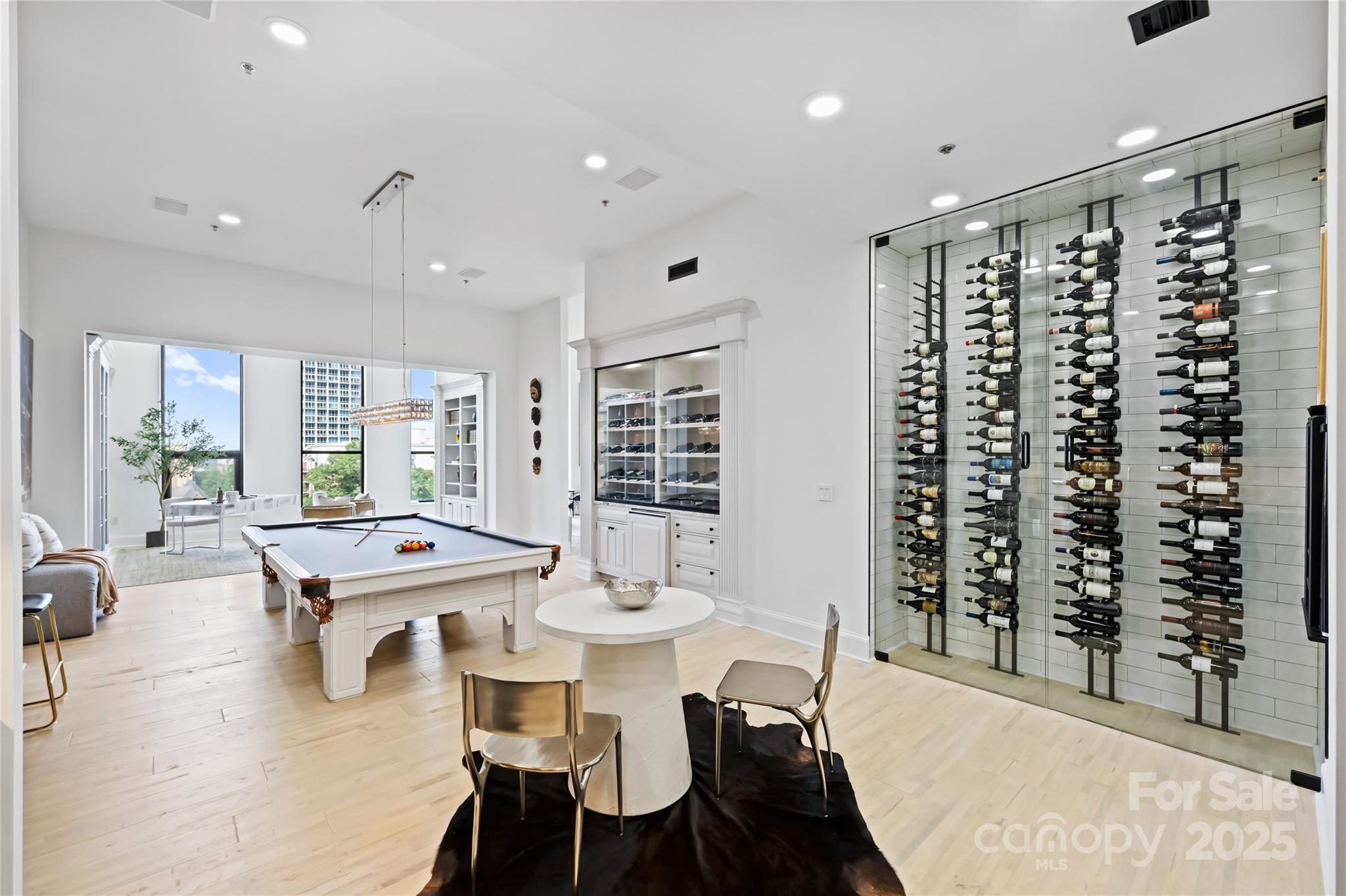 127 North Tryon Street, Unit 615 Charlotte, NC 28246 - Photo 14 of 48 a dining room with furniture a wooden floor and chandelier