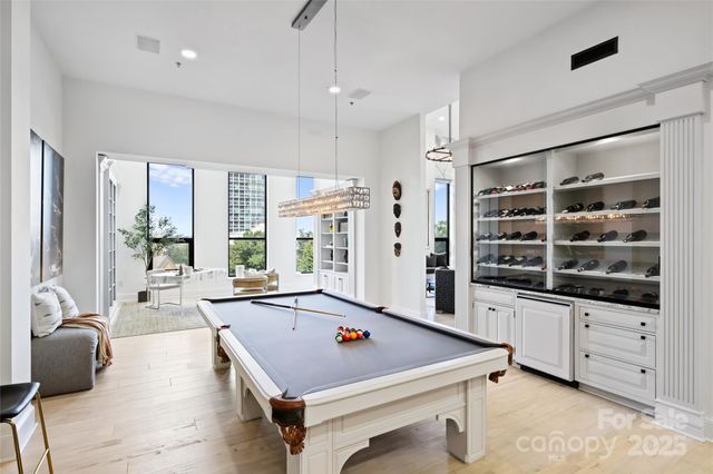 a room with pool table and windows