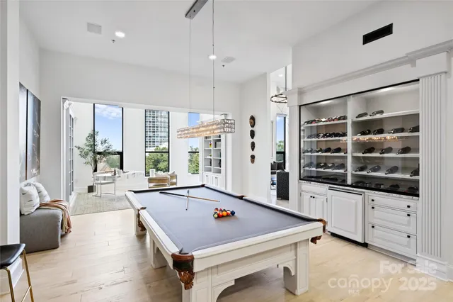 a room with pool table and windows