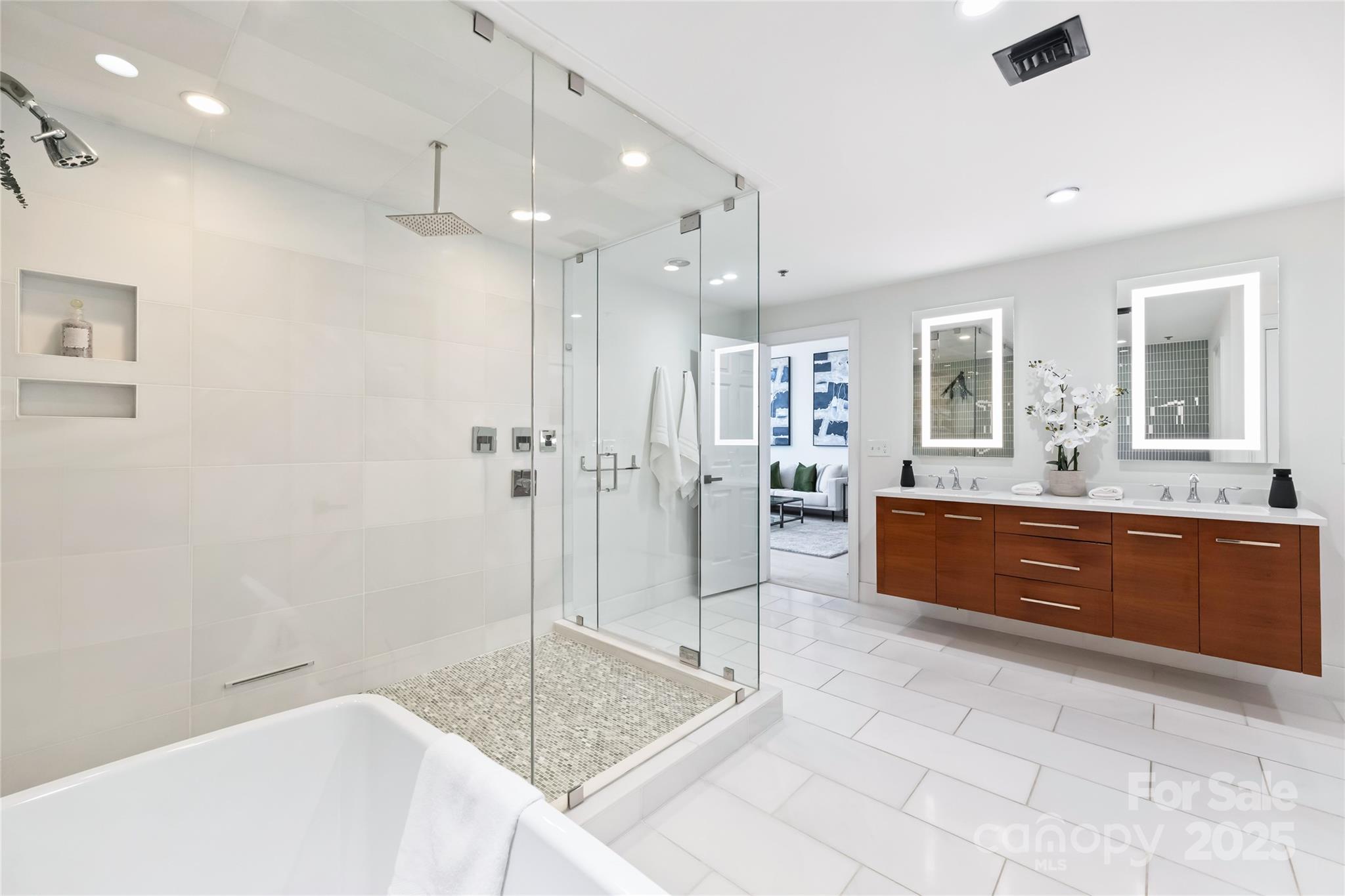127 North Tryon Street, Unit 615 Charlotte, NC 28246 - Photo 21 of 48 a spacious bathroom with a granite countertop sink mirror and bathtub