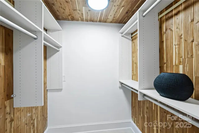 a view of a hallway with wooden floor and entryway