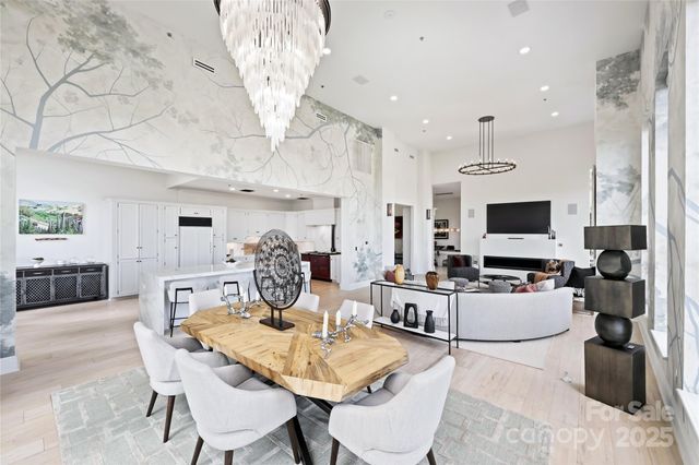a living room with furniture a flat screen tv and kitchen view