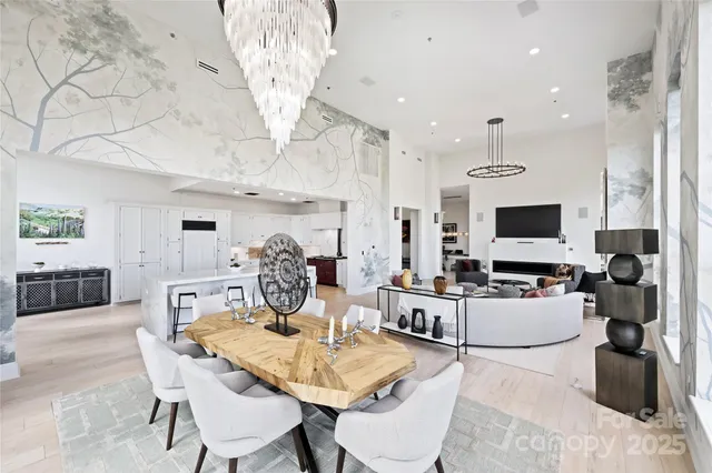 a living room with furniture a flat screen tv and kitchen view
