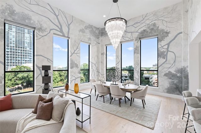 a very nice looking living room with a large window and furniture