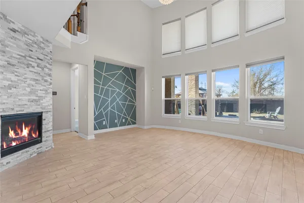 a view of an empty room with a fireplace and a window