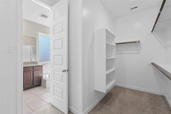 a view of a room with windows and closet