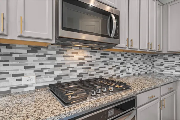 a stove top oven sitting inside of a kitchen