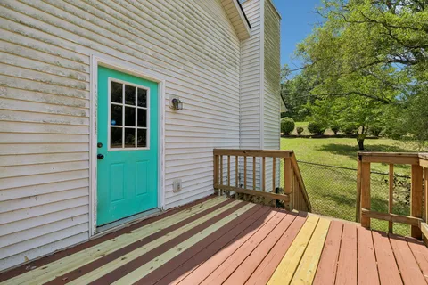 a view of balcony with wooden floor and fence