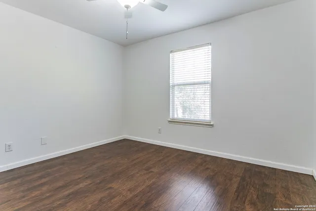 wooden floor in an empty room with a window