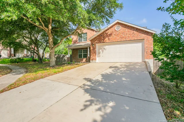 a front view of a house with a yard and a garage