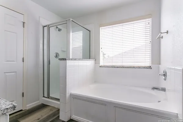 a bathroom with a bathtub and a window