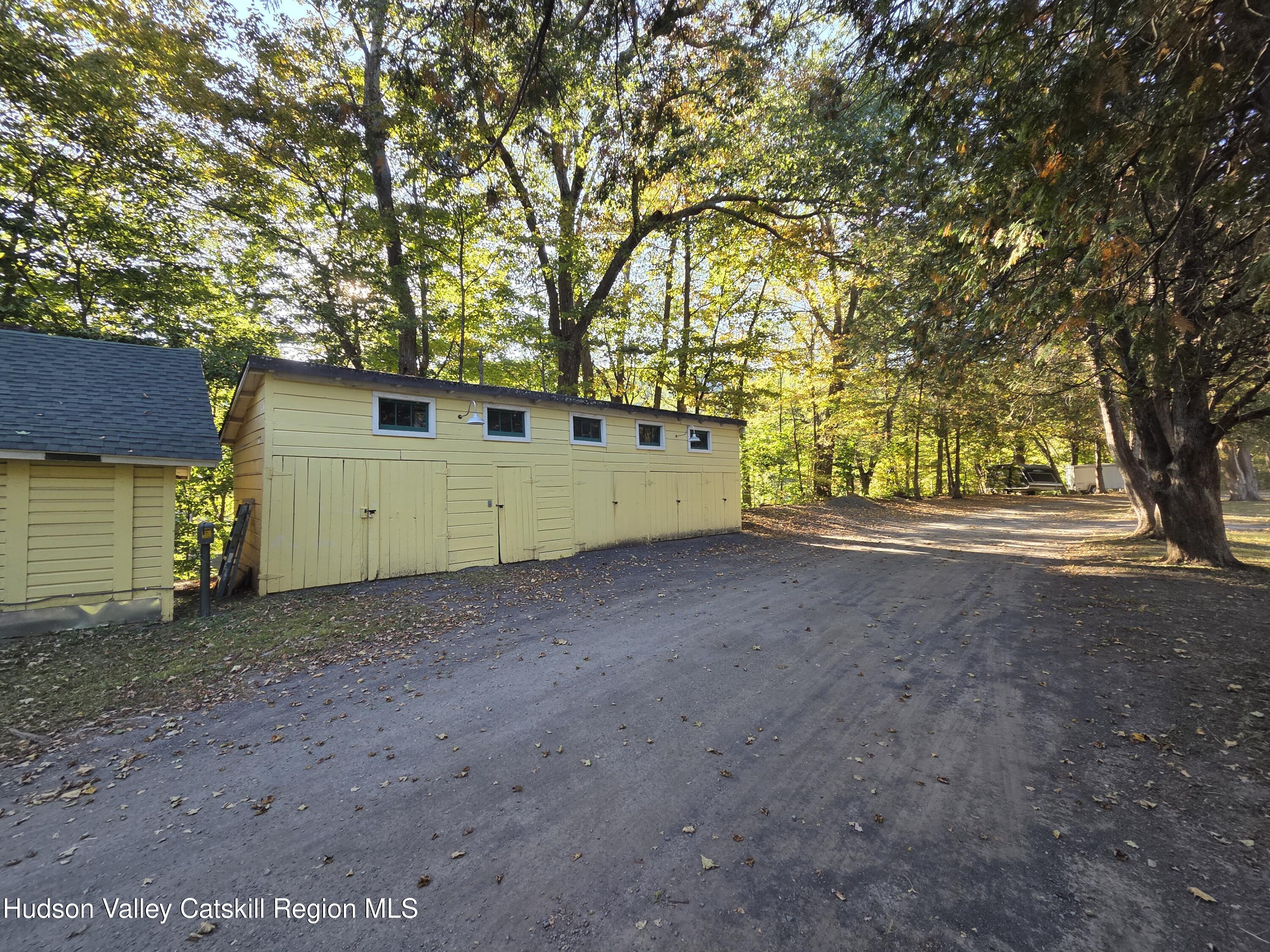 37-69 Mt Ava Maria Road Phoenicia, NY 12464 - Photo 11 of 27 a view of a house with a large tree and wooden fence