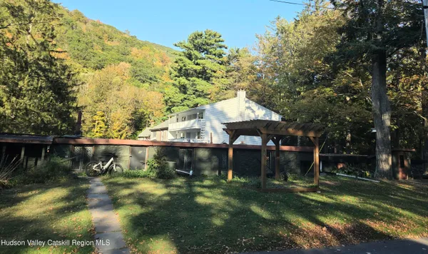 a backyard of a house with yard and tree