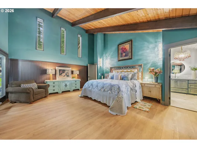 a bedroom with furniture and a wooden floor