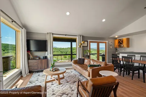a view of kitchen with stainless steel appliances granite countertop sink stove dining table and chairs