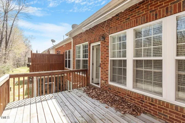 a view of a house with a wooden deck