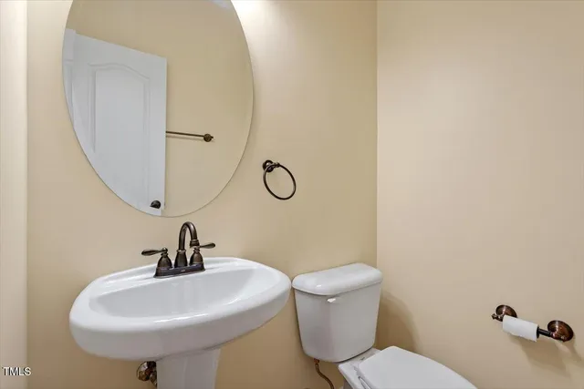 a bathroom with a sink mirror and toilet