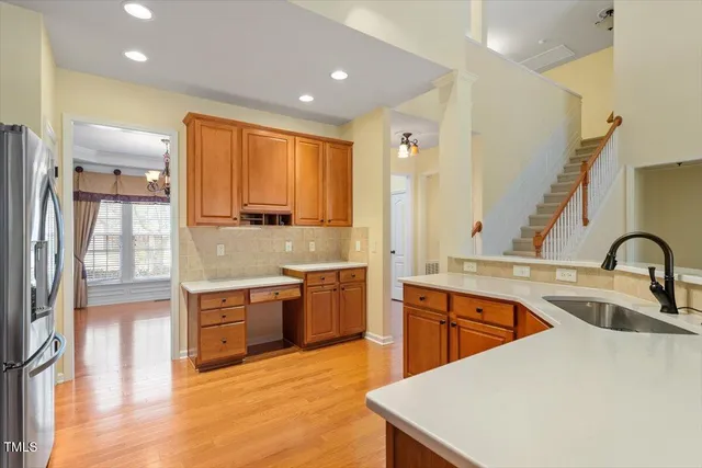 a large kitchen with stainless steel appliances granite countertop a sink and a stove