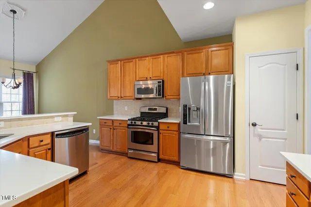 a kitchen with a refrigerator sink and wooden floor