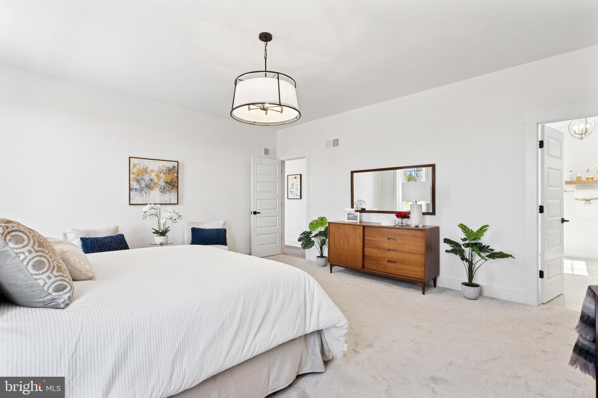 285 Ledger Drive, Unit 61 Hanover, PA 17331 - Photo 28 of 41 a bedroom with a bed and a chandelier