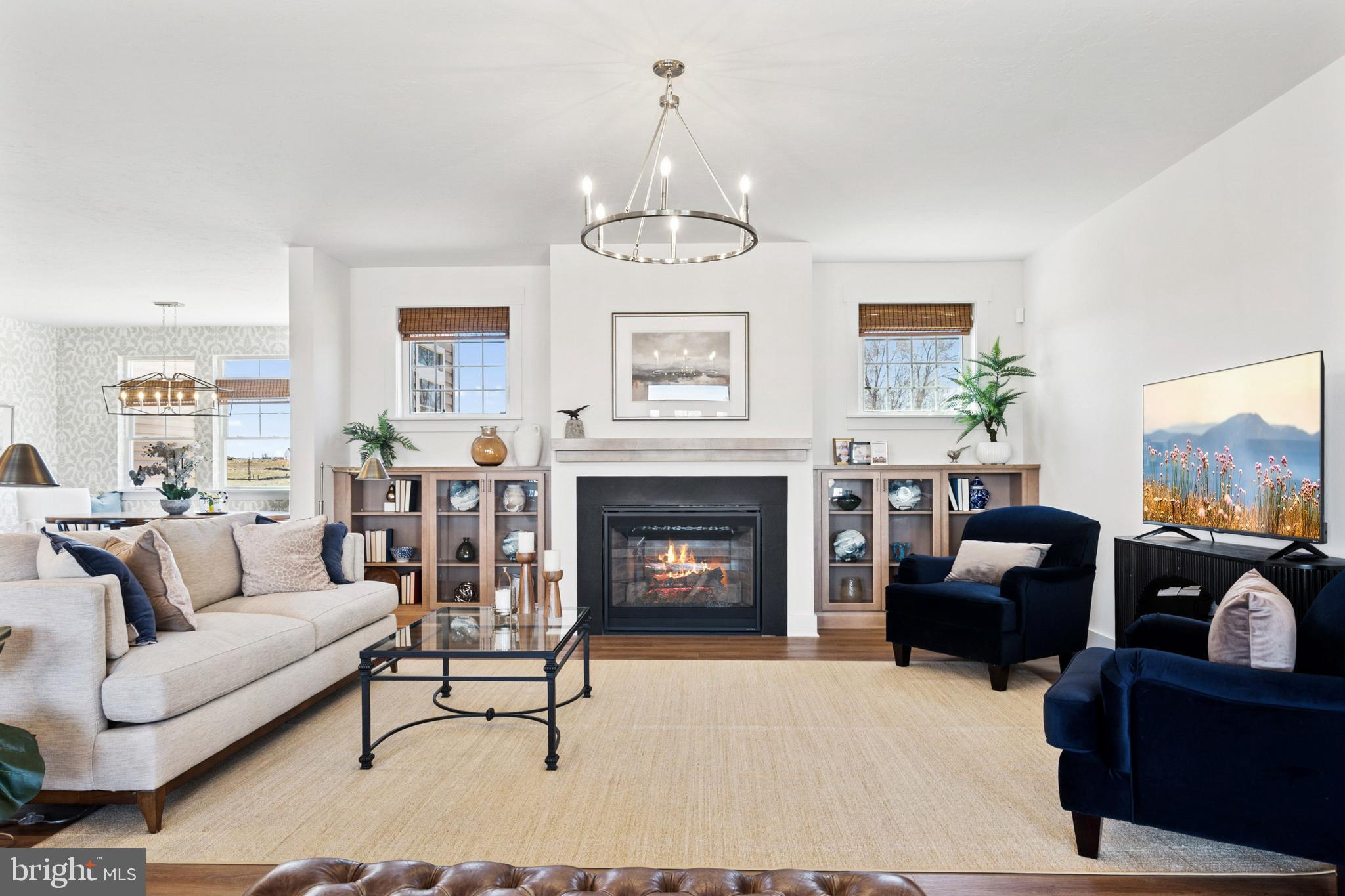 285 Ledger Drive, Unit 61 Hanover, PA 17331 - Photo 6 of 41 a living room with furniture a fireplace and a chandelier