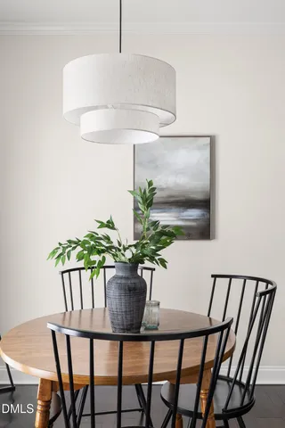 a dining room with furniture and a potted plant