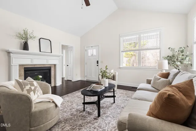 a living room with furniture a fireplace and a window