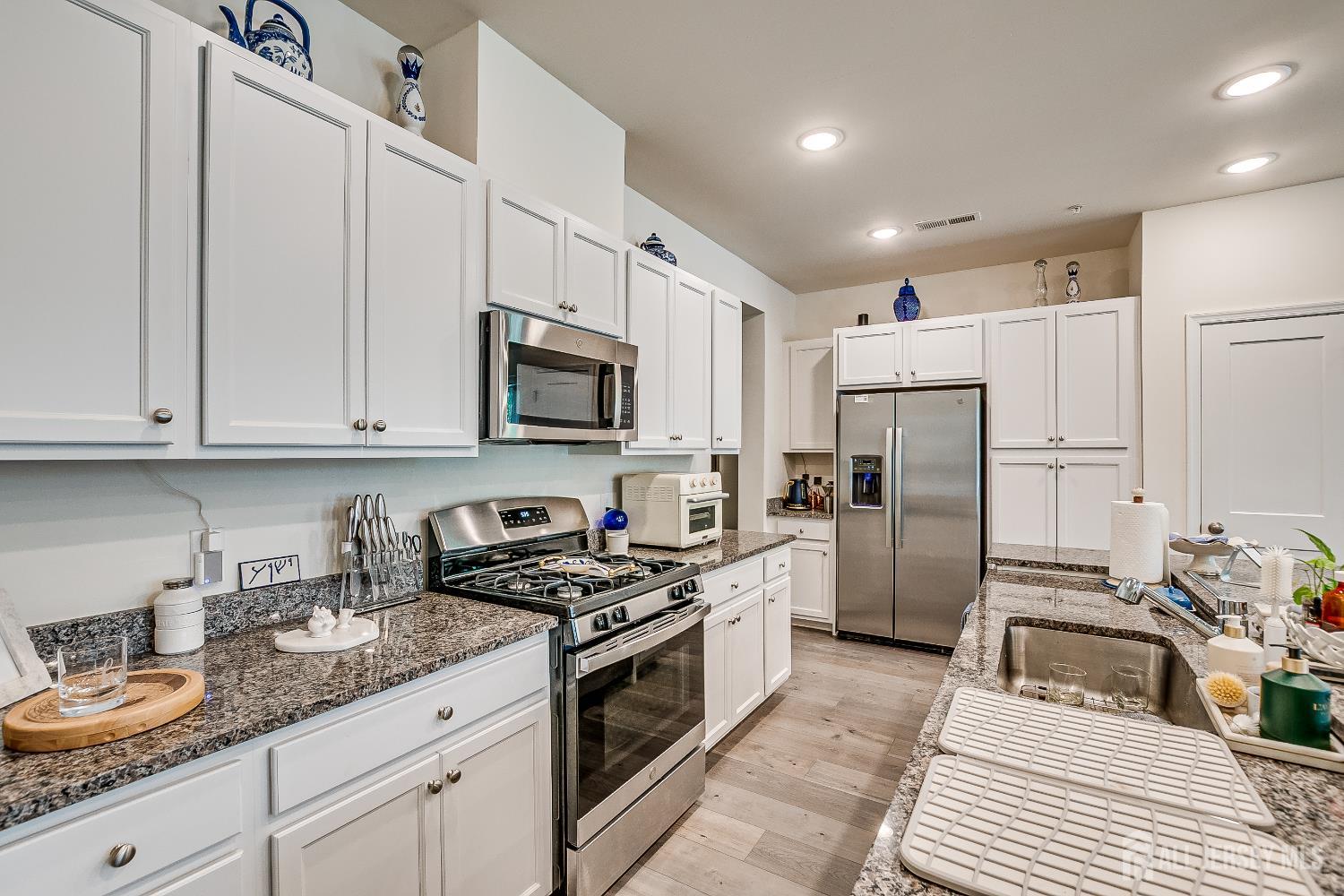 224 Park Lane Dunellen, NJ 08812 - Photo 15 of 40 a kitchen with refrigerator a sink a stove a microwave and cabinets