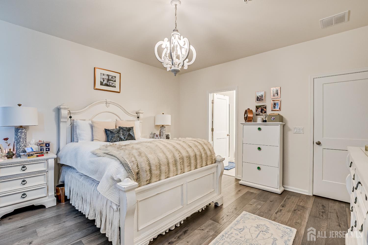 224 Park Lane Dunellen, NJ 08812 - Photo 23 of 40 a bed room with a bed and a chandelier