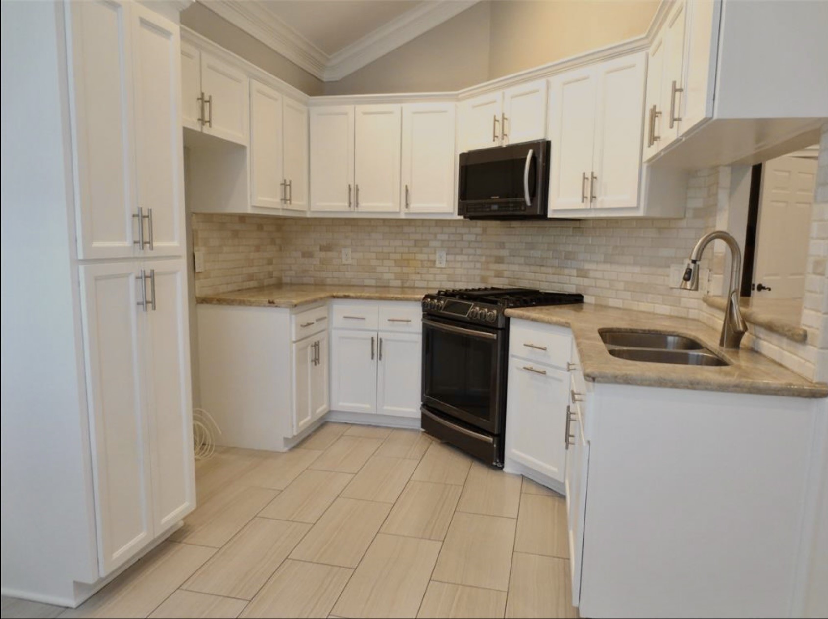 8214 Split Oak Drive Houston, TX 77040 - Photo 4 of 15 a kitchen with stainless steel appliances granite countertop a sink and a stove
