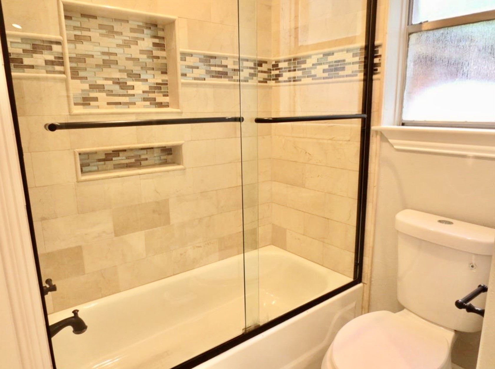 8214 Split Oak Drive Houston, TX 77040 - Photo 7 of 15 a bathroom with a toilet and a shower