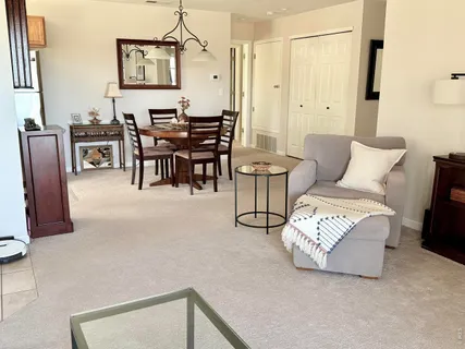 a living room with furniture a table and a painting