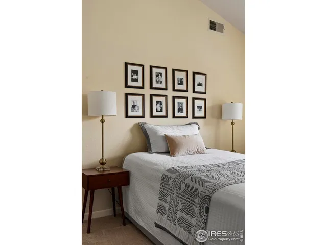 a bedroom with a bed and a wall painting