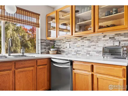 a kitchen with stainless steel appliances granite countertop a sink and a window