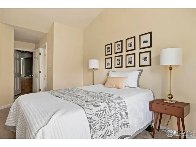 a bedroom with a bed and a lamp on table