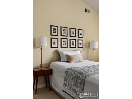 a bedroom with a bed and a wall painting