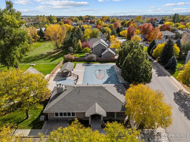 an aerial view of a house with a yard basket ball court and outdoor seating