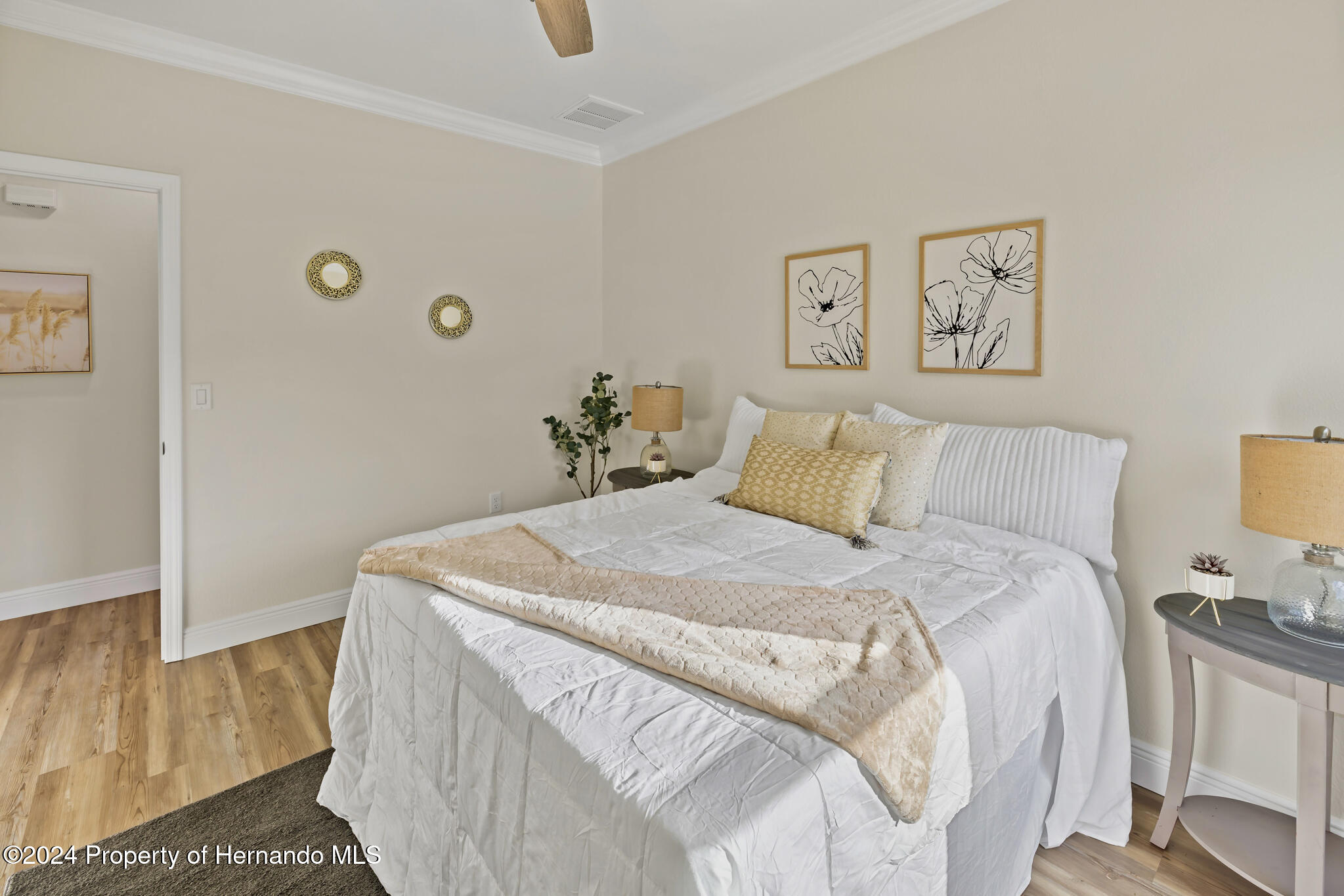 6435 Finance Avenue Weeki Wachee, FL 34607 - Photo 18 of 35 a bedroom with a bed and painting on the wall