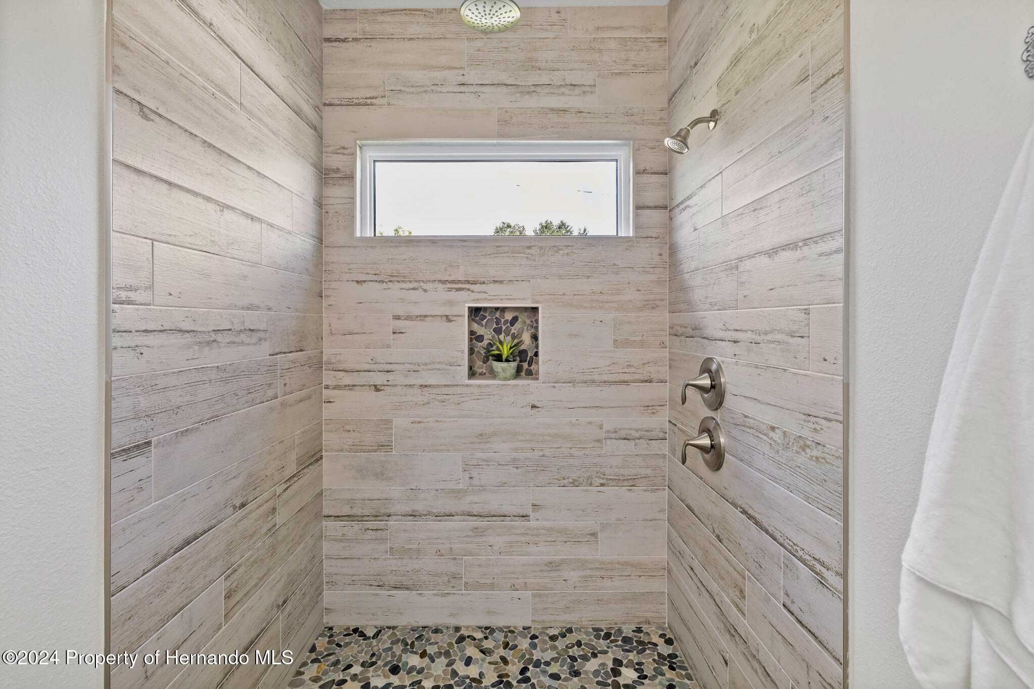 6435 Finance Avenue Weeki Wachee, FL 34607 - Photo 20 of 35 a bathroom with a shower