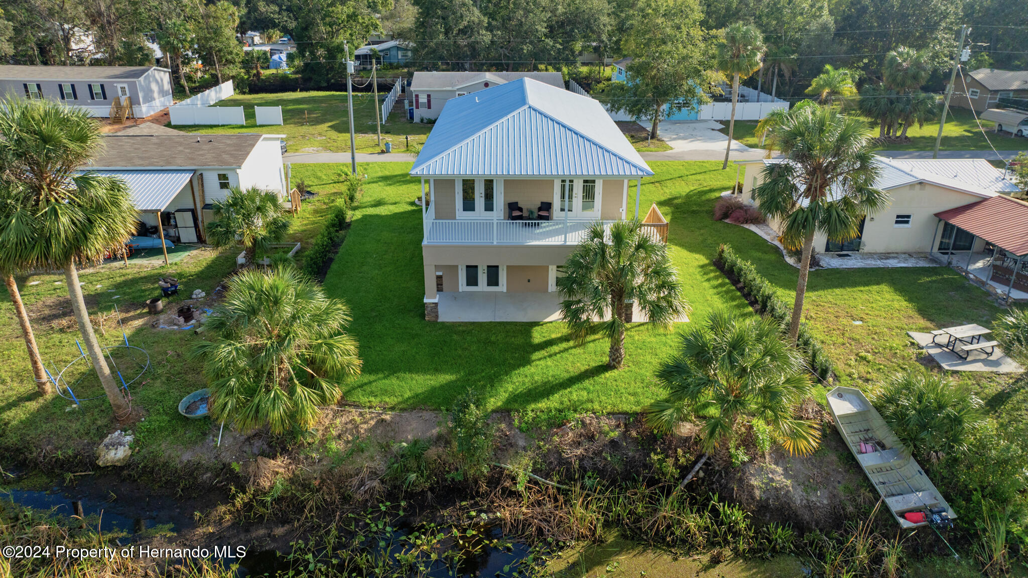 6435 Finance Avenue Weeki Wachee, FL 34607 - Photo 3 of 35 a aerial view of a house with swimming pool and large trees