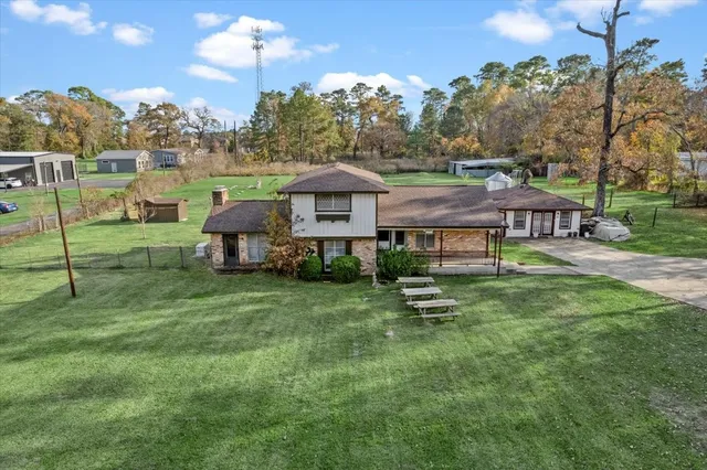 a front view of a house with a yard table and chairs
