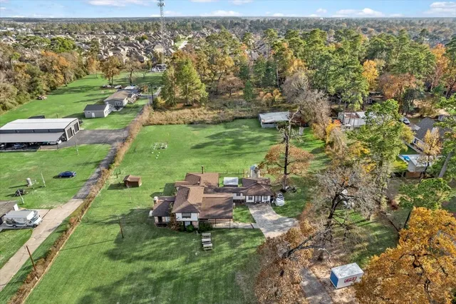 an aerial view of a house with a yard