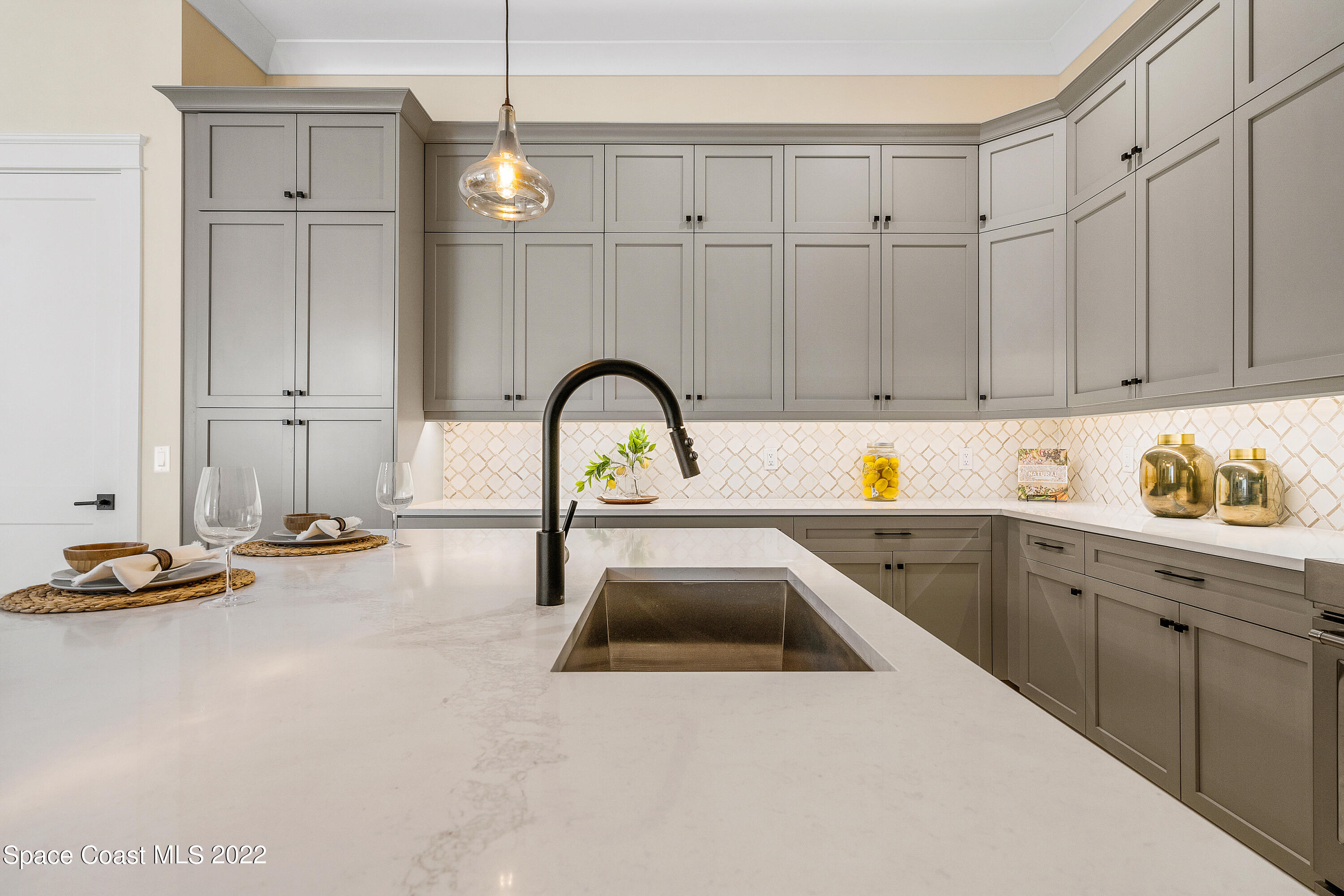 20 Strand Drive Vero Beach, FL 32963 - Photo 13 of 36 a kitchen with sink and cabinets