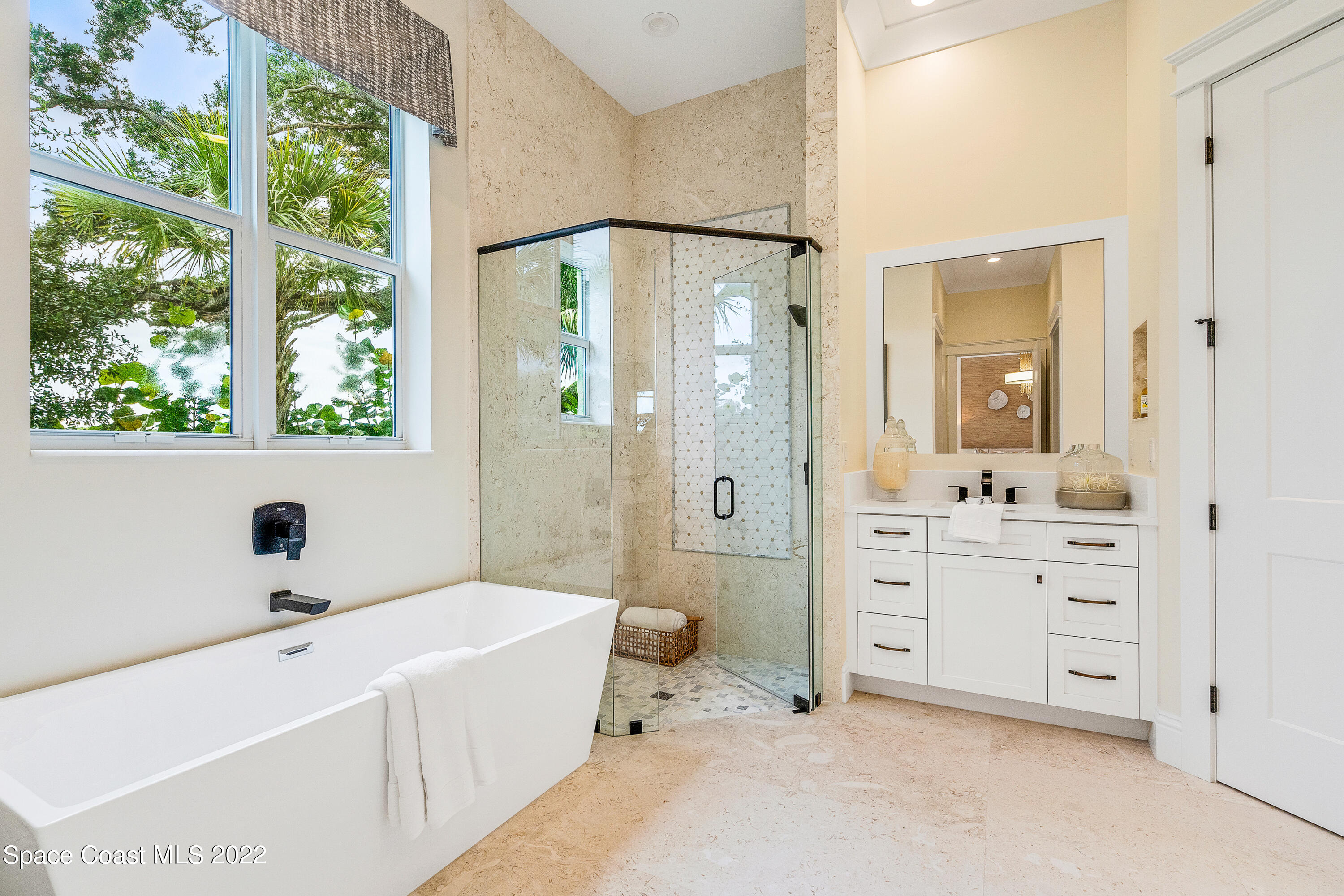 20 Strand Drive Vero Beach, FL 32963 - Photo 20 of 36 a bathroom with a tub a sink and a large mirror