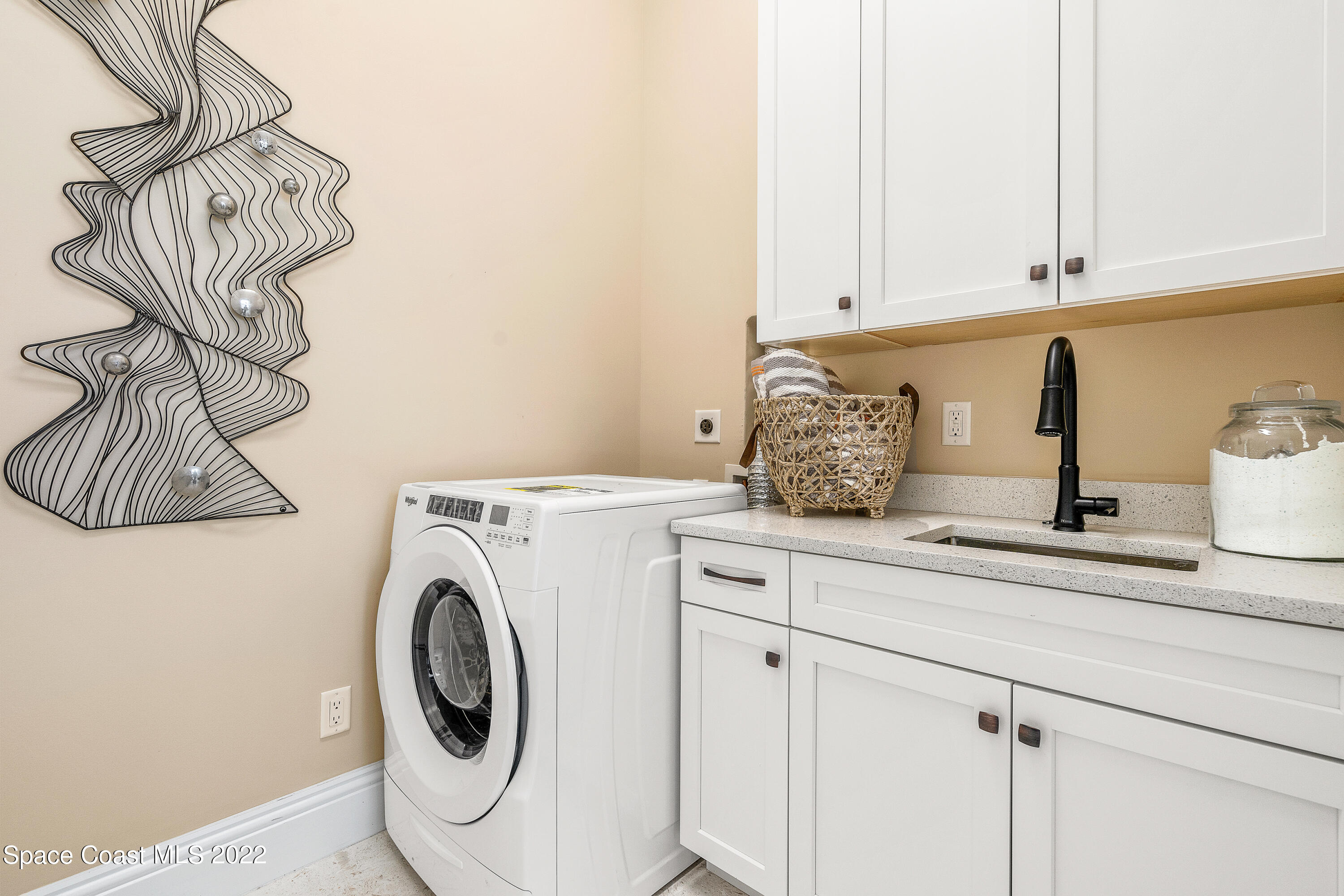 20 Strand Drive Vero Beach, FL 32963 - Photo 33 of 36 a kitchen with a sink and a washer dryer