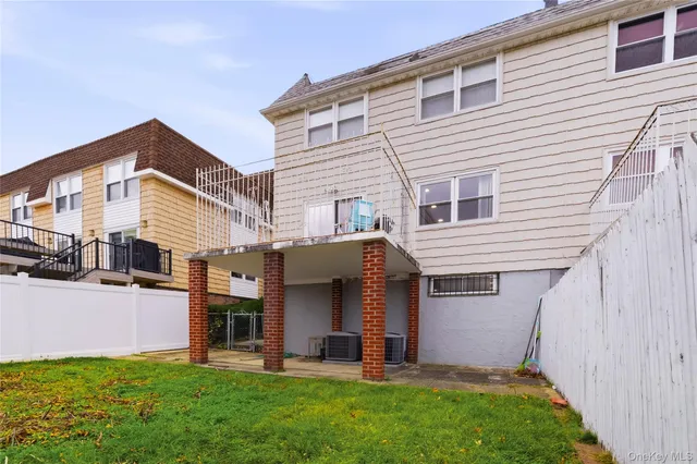 a view of a house with a yard and pathway