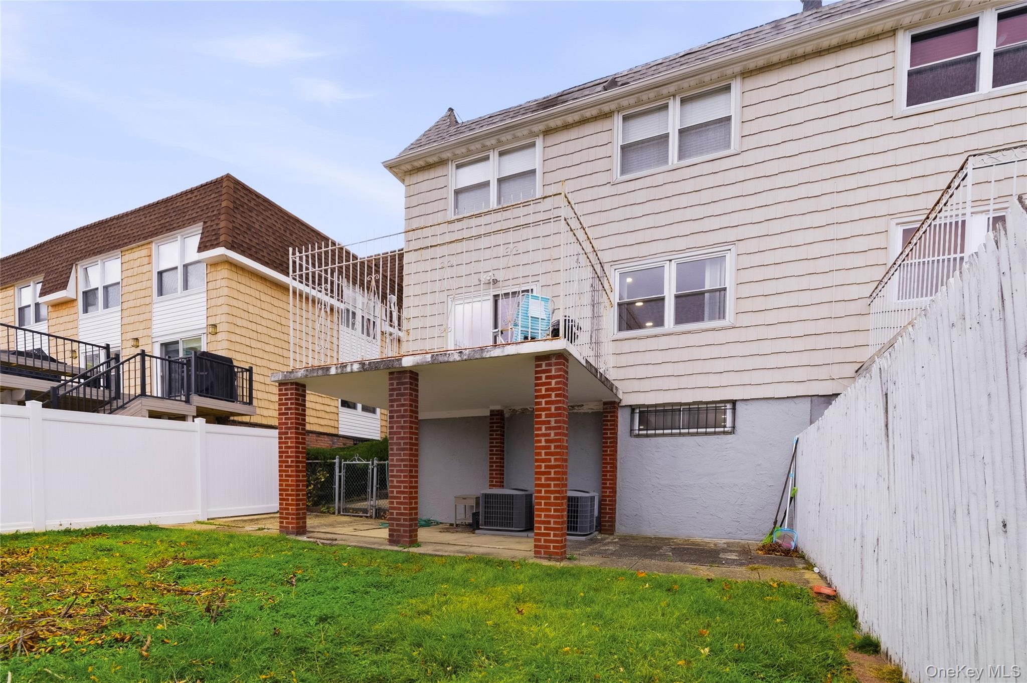 15-69 215th Street, Unit 1 Queens, NY 11360 - Photo 19 of 20 a view of a house with a yard and pathway