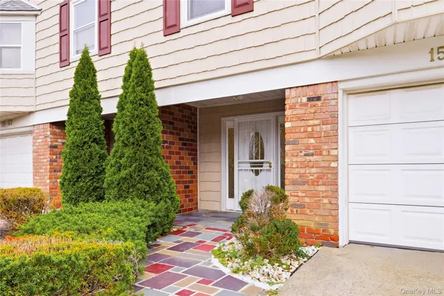 a front view of a house with plants